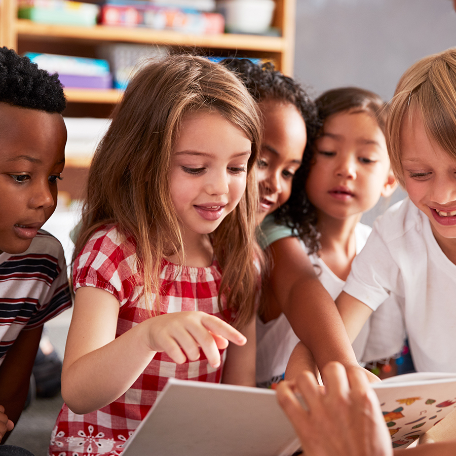 elementary kids looking at book